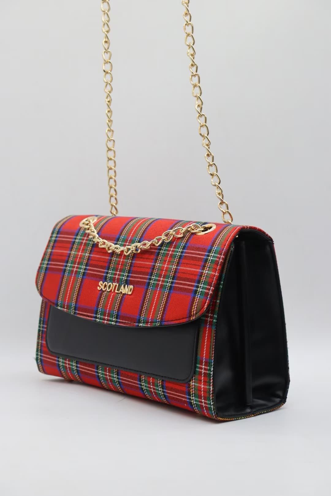Red tartan crossbody bag with structured flap and gold chain strap