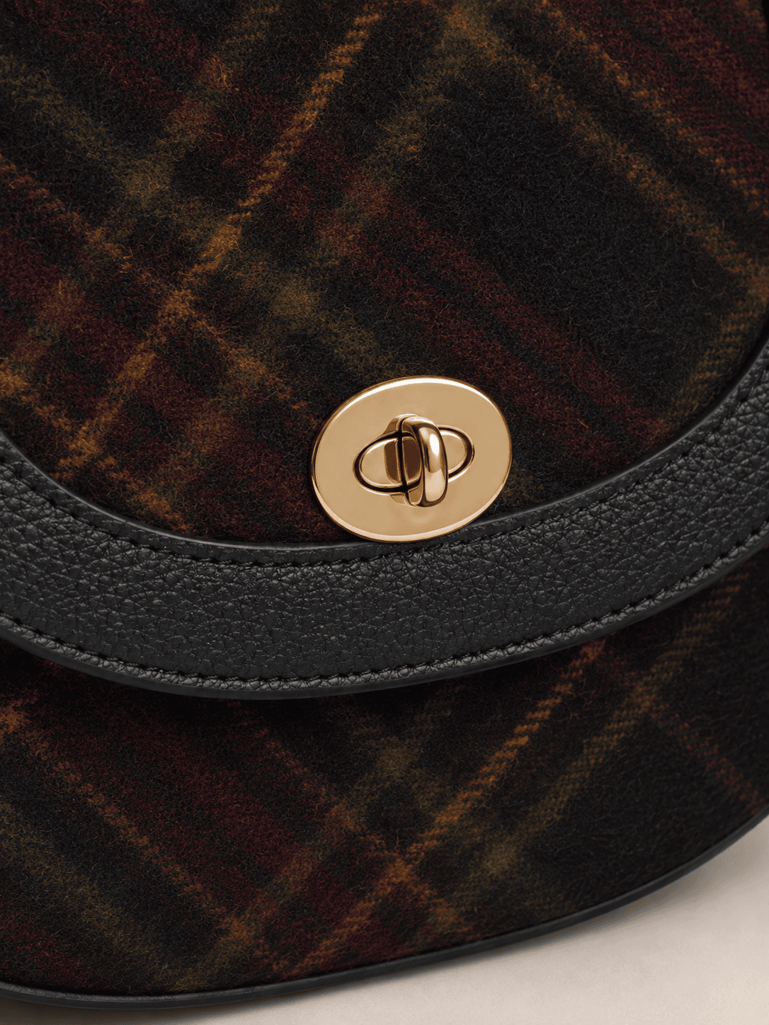 Tartan saddle crossbody bag turn-lock and pattern placement detail